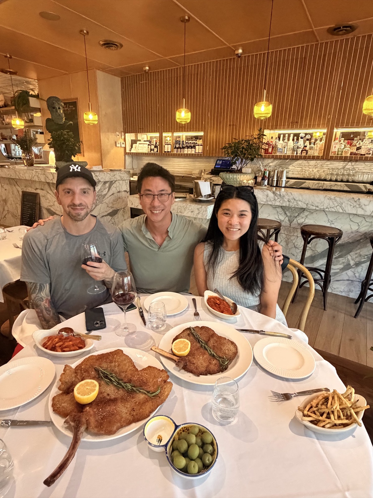 Dinner at a Miami restaurant with two fellow builders, plates of breaded cutlets and fries on the table.